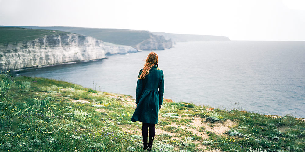 Woman staring out to sea