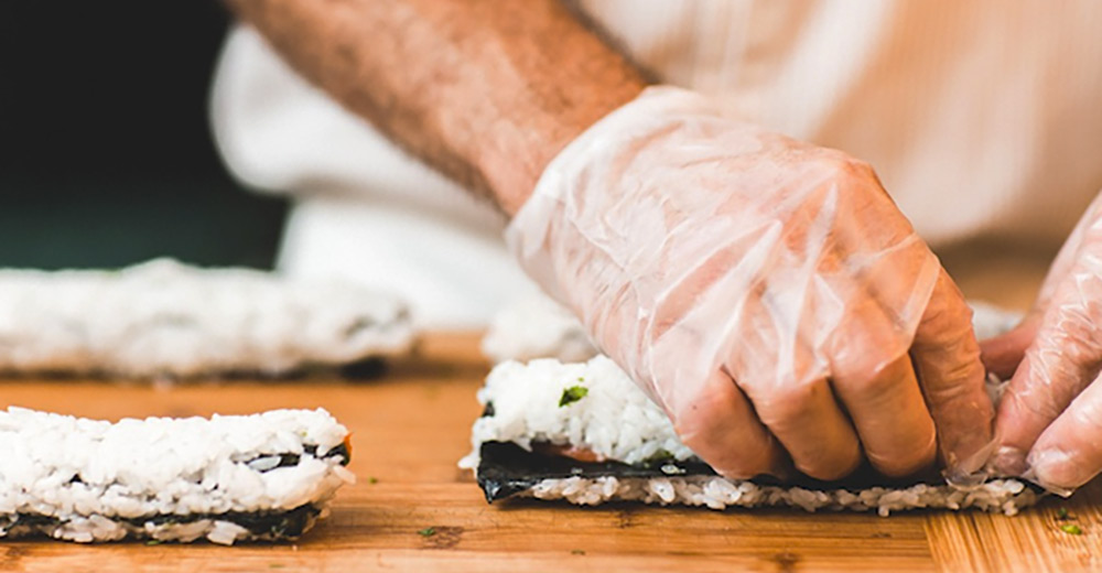 hands preparing sushi