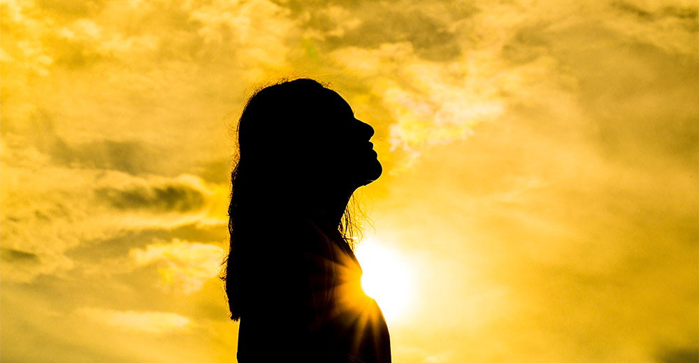 woman standing in sunlight