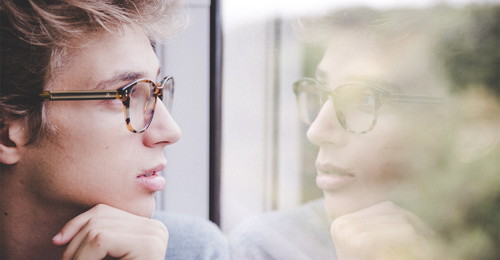Man looking at his reflection